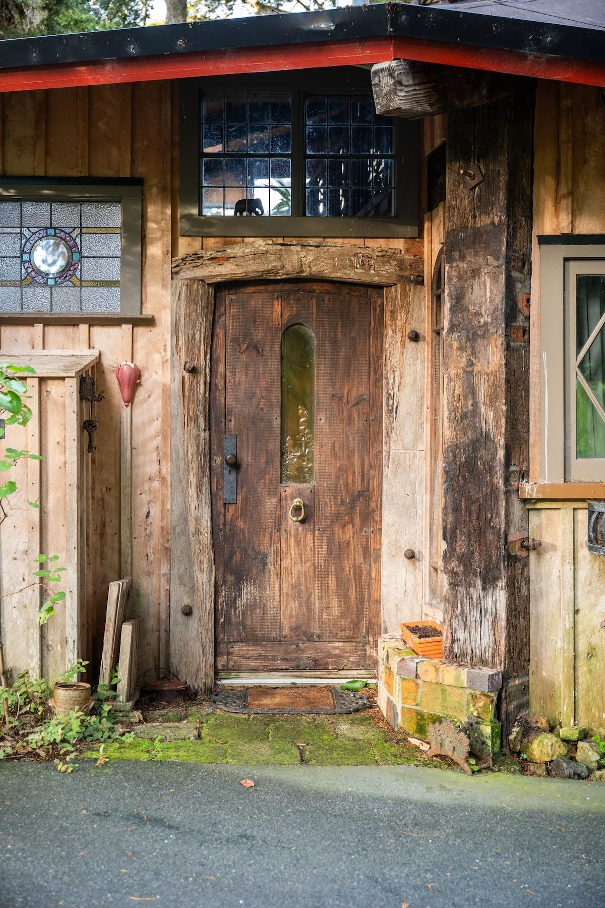 The rustic timber front door with a clock mounted above it.