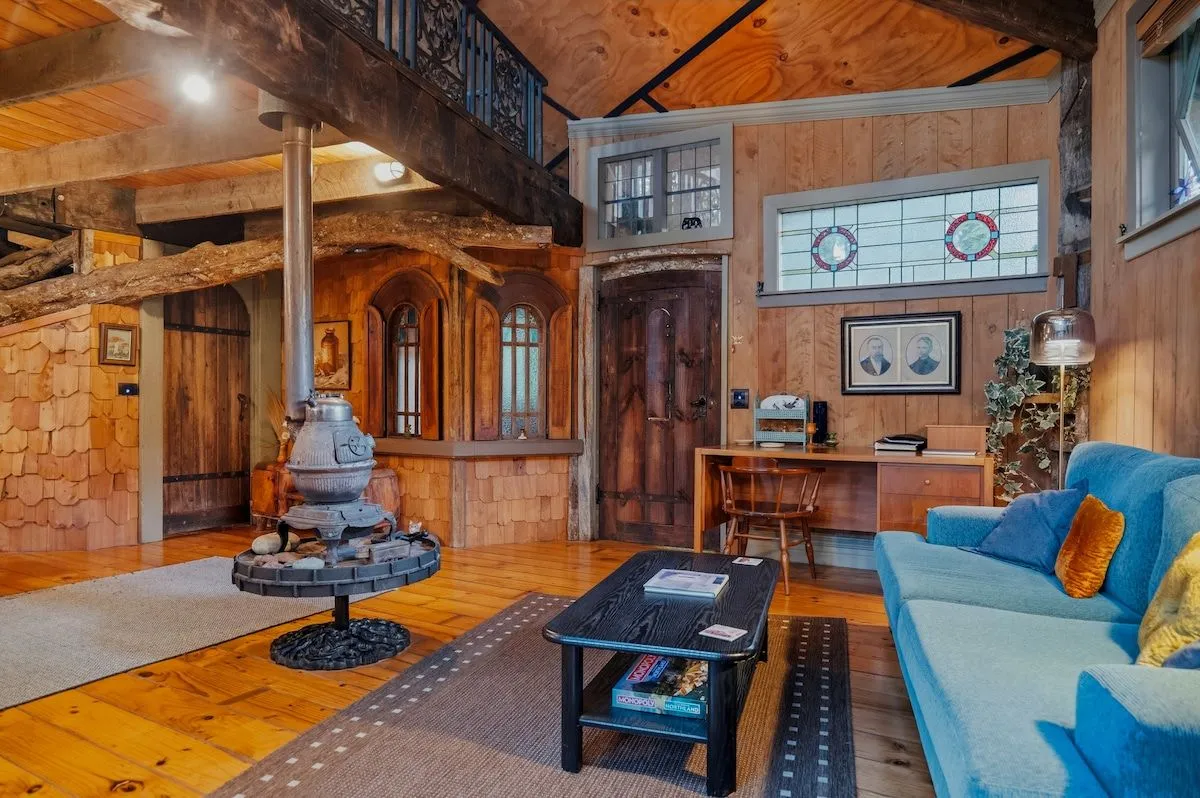The living area from the far corner, with the timber mezzanine visible overhead.